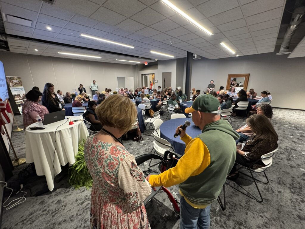 Brookwood Citizen praying over Brookwood Way Conference attendees before a Center for Learning session